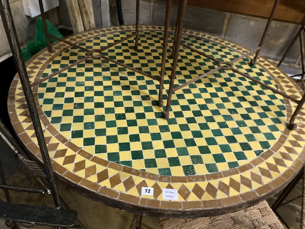 An iron framed circular tiled top table, a set of six iron framed chairs, with rope work seats and a wrought iron easel, table 128 diam